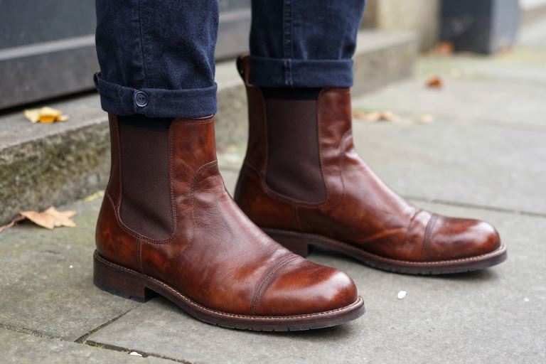 A pair of large brown leather Chelsea boots