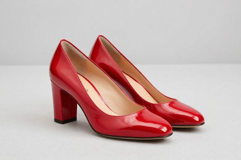 A pair of large red block-heel court shoes