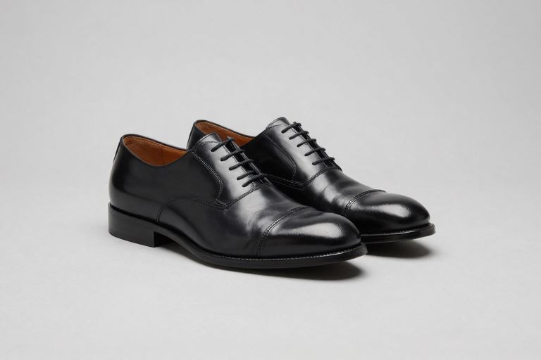 A pair of large black leather men's shoes